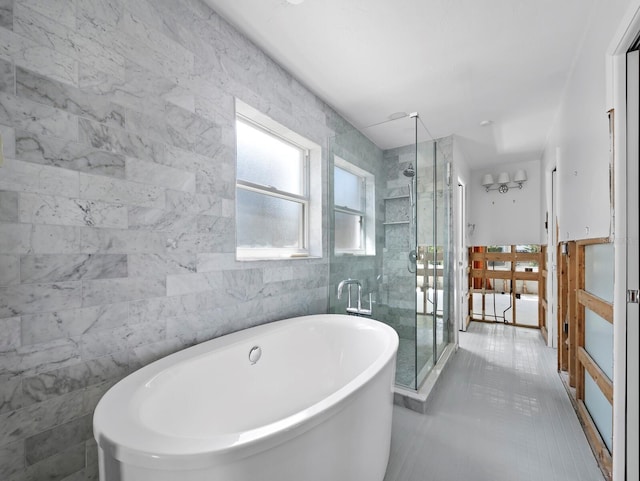 611 Hibiscus Way, Longboat Key, FL 34228 - bathroom featuring a freestanding tub, a stall shower, and tile walls