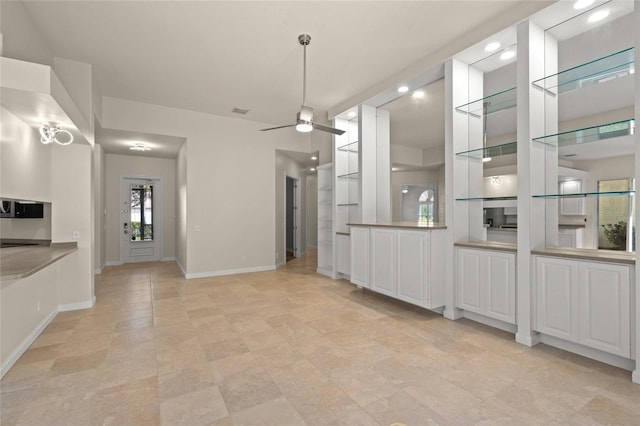 unfurnished dining area featuring ceiling fan