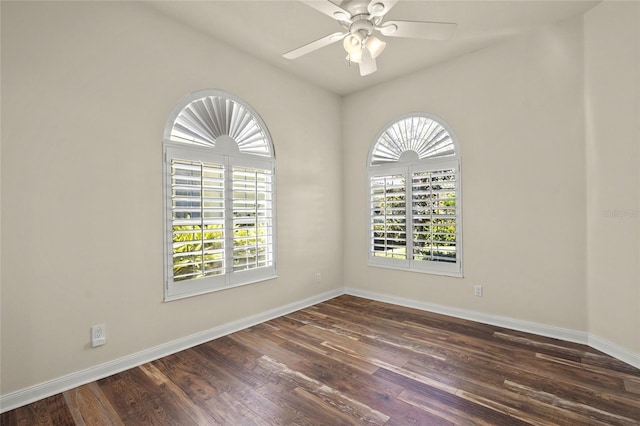 empty room featuring ceiling fan and dark wood-type flooring