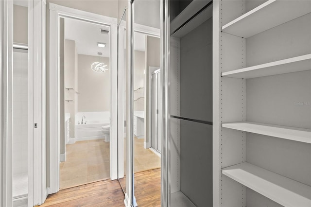 walk in closet featuring hardwood / wood-style flooring