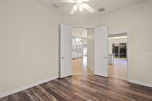 unfurnished room featuring dark hardwood / wood-style flooring, a wealth of natural light, and ceiling fan