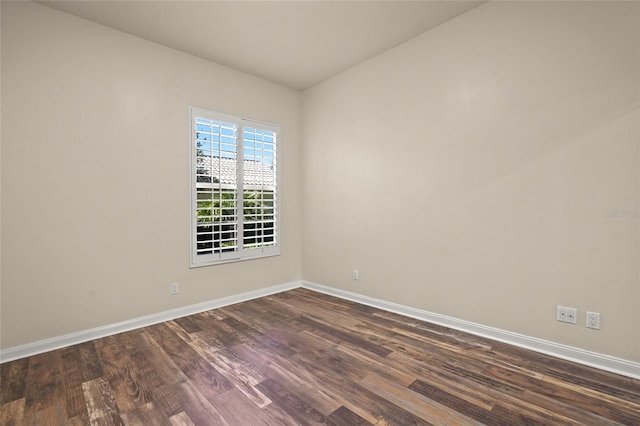 spare room with dark hardwood / wood-style flooring