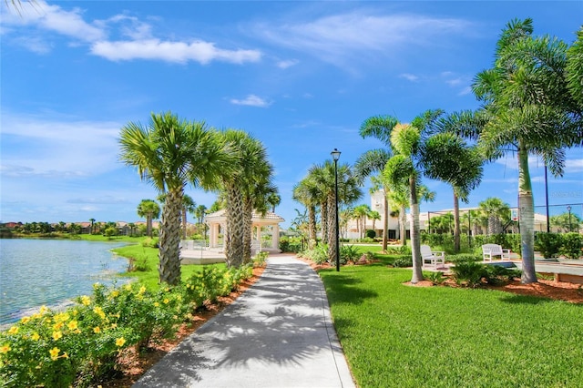 view of property's community with a yard and a water view