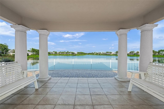 view of pool featuring a water view and a patio area