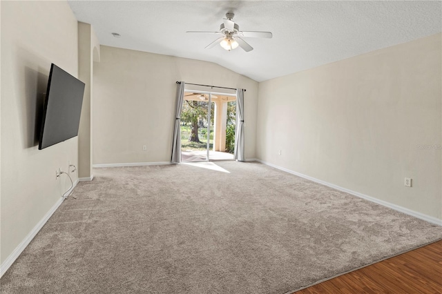 empty room featuring ceiling fan, light wood-type flooring, and lofted ceiling