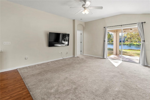 unfurnished living room with wood-type flooring, ceiling fan, and lofted ceiling