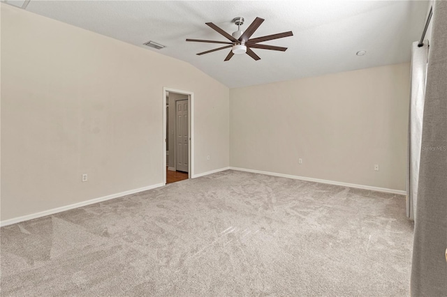 carpeted spare room featuring ceiling fan and lofted ceiling