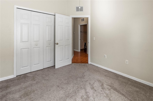 unfurnished bedroom with a closet and carpet floors