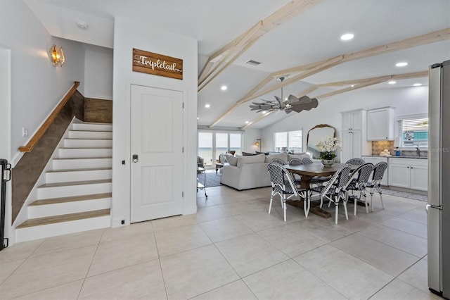 dining area with lofted ceiling with beams, ceiling fan, and light tile patterned floors