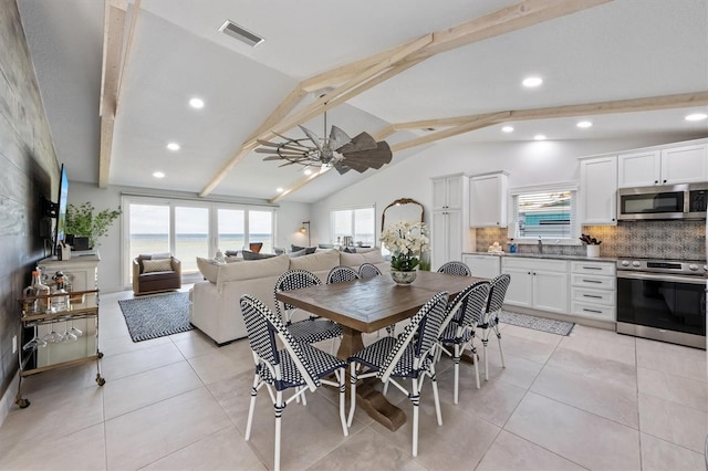 tiled dining area featuring vaulted ceiling with beams and ceiling fan