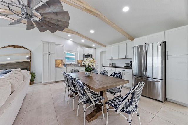 tiled dining room with vaulted ceiling with beams, ceiling fan, and sink