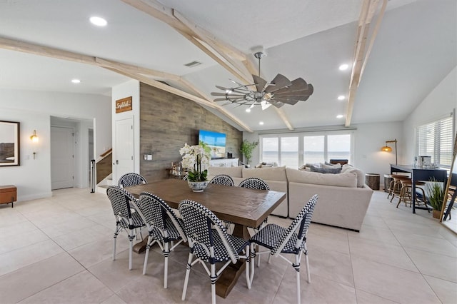 dining area featuring ceiling fan, light tile patterned flooring, and lofted ceiling with beams