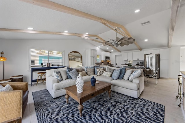 tiled living room with lofted ceiling with beams, ceiling fan, and a textured ceiling