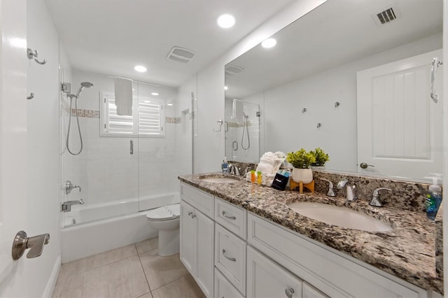 full bathroom with tile patterned flooring, vanity, toilet, and enclosed tub / shower combo