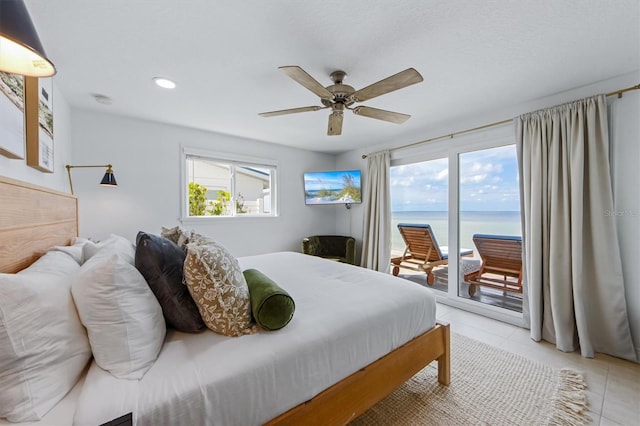 bedroom with ceiling fan, light tile patterned flooring, access to outside, and multiple windows