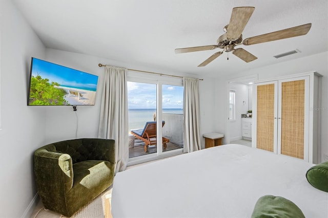 bedroom featuring ensuite bath and ceiling fan