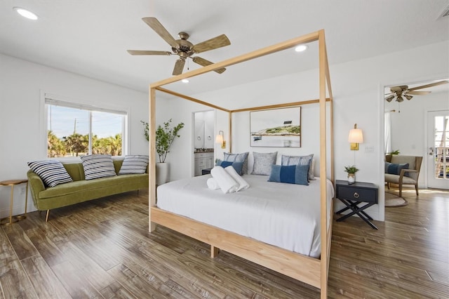 bedroom featuring multiple windows, dark hardwood / wood-style flooring, ensuite bathroom, and ceiling fan