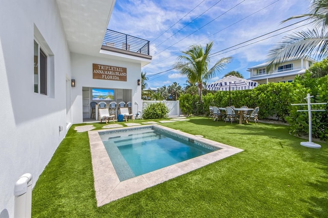 view of pool with a lawn