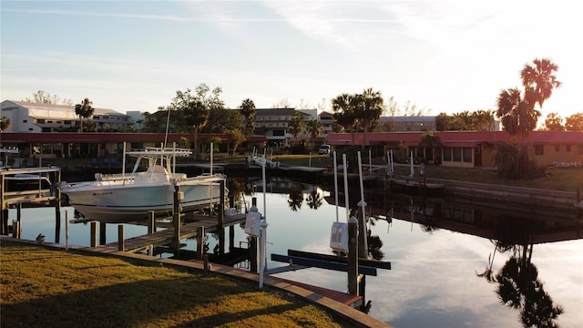 dock area with a water view and a yard