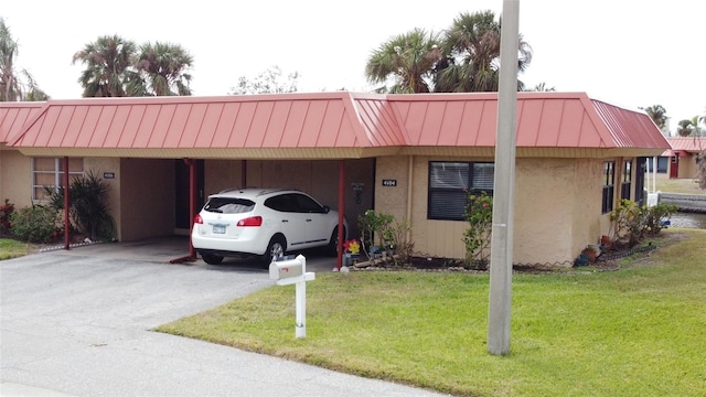 ranch-style house with a carport and a front yard