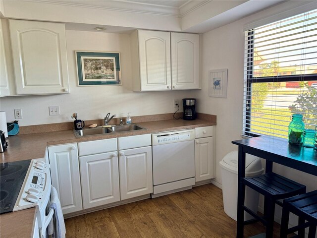 kitchen with white cabinetry, sink, dark wood-type flooring, white appliances, and ornamental molding