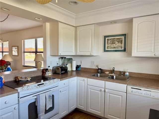 kitchen with sink, white cabinets, white appliances, and ornamental molding