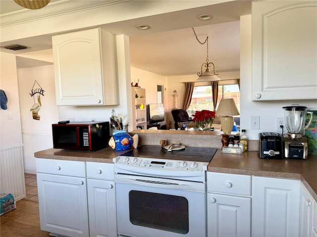 kitchen with white range with electric cooktop and white cabinetry