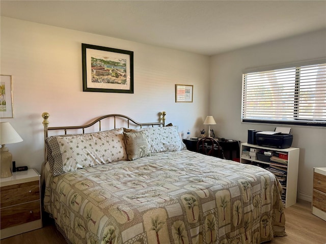 bedroom with hardwood / wood-style flooring