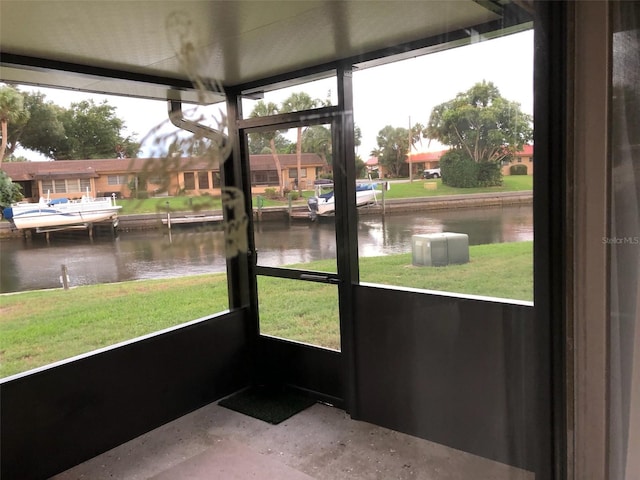 unfurnished sunroom with a water view and plenty of natural light