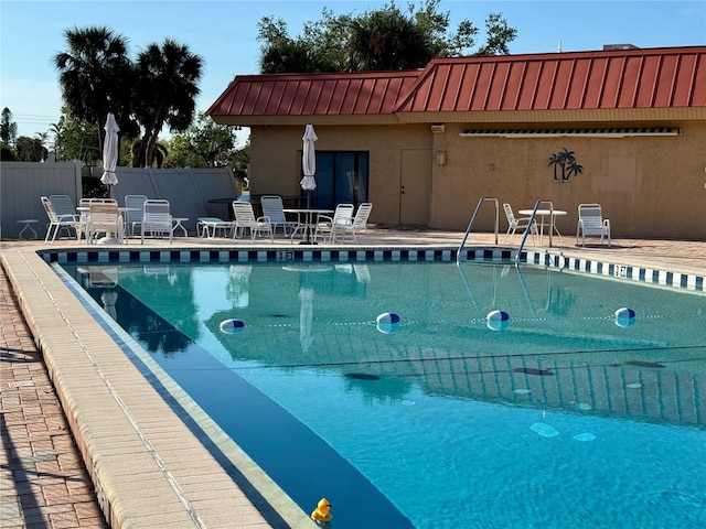 view of swimming pool featuring a patio area