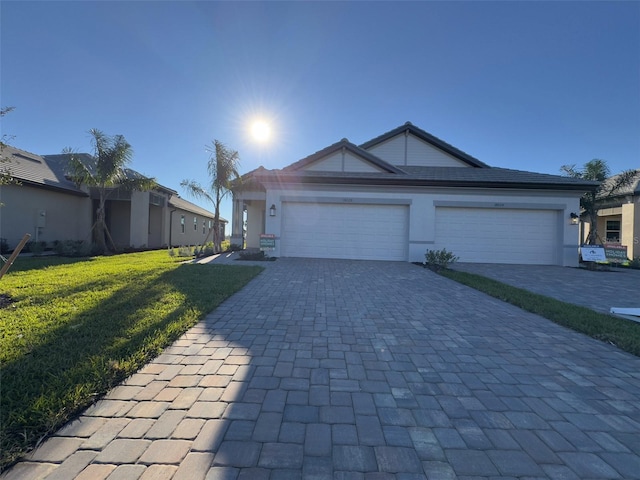 single story home with a front lawn and a garage