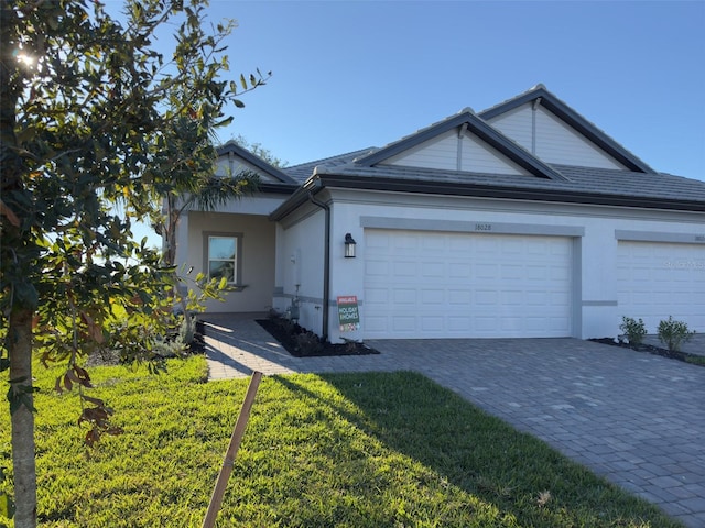 single story home with a front yard and a garage