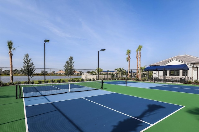 view of tennis court featuring basketball hoop