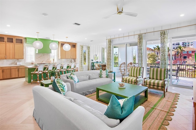 living room featuring light parquet flooring and ceiling fan