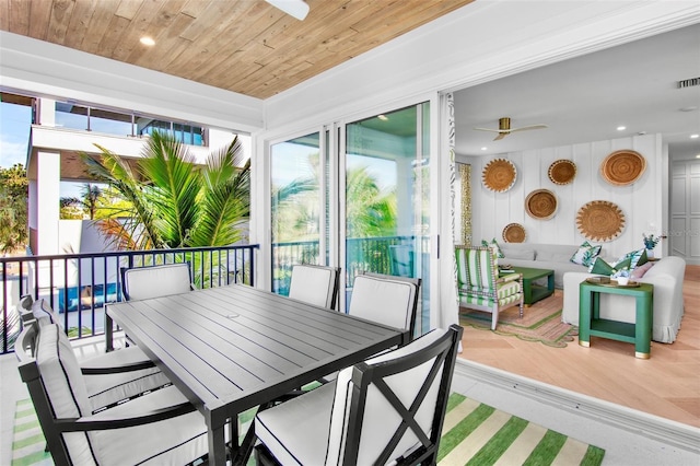 sunroom / solarium with wood ceiling and ceiling fan