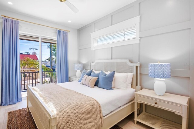 bedroom featuring access to exterior, light hardwood / wood-style flooring, and ceiling fan