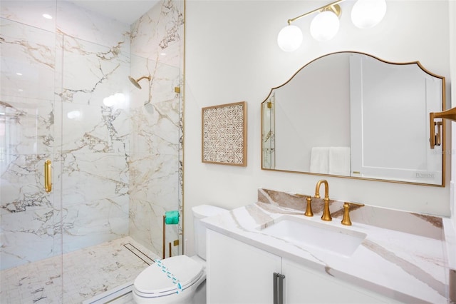 bathroom featuring vanity, toilet, and a shower with door