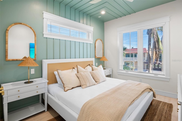 bedroom featuring multiple windows and light hardwood / wood-style flooring