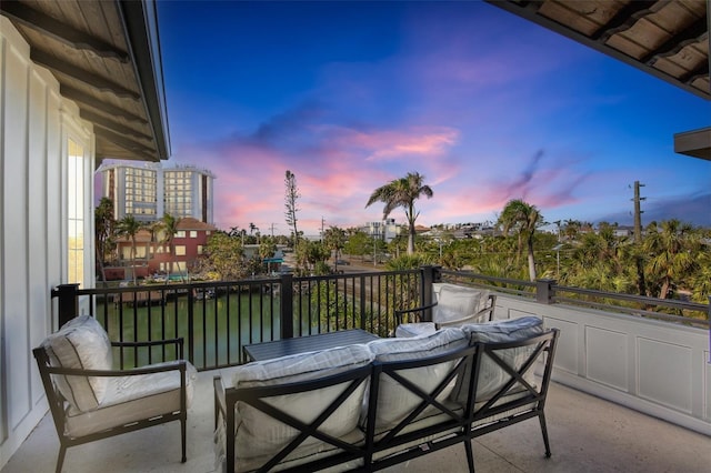 balcony at dusk featuring outdoor lounge area