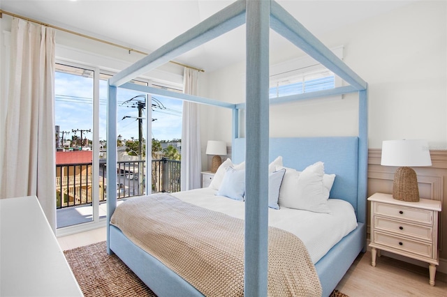 bedroom featuring access to exterior and light hardwood / wood-style floors