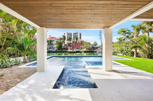 view of pool featuring a water view and a patio area