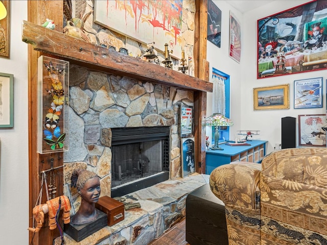 living room featuring hardwood / wood-style flooring and a stone fireplace