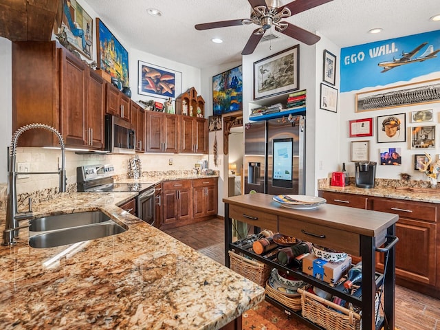 3888 Shady Brook Ln, Sarasota, FL 34243 - kitchen with appliances with stainless steel finishes, a sink, a textured ceiling, ceiling fan, and decorative backsplash