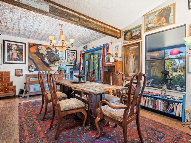 dining room featuring hardwood / wood-style flooring, lofted ceiling with beams, a textured ceiling, and a notable chandelier