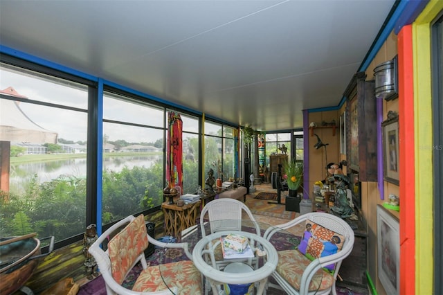 sunroom / solarium with a water view