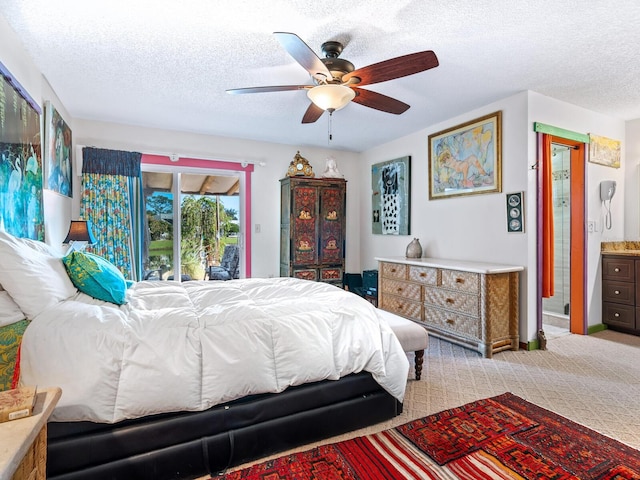 carpeted bedroom with access to outside, ceiling fan, ensuite bathroom, and a textured ceiling