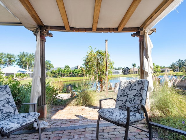 view of patio with a water view