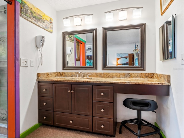 bathroom featuring vanity and a textured ceiling