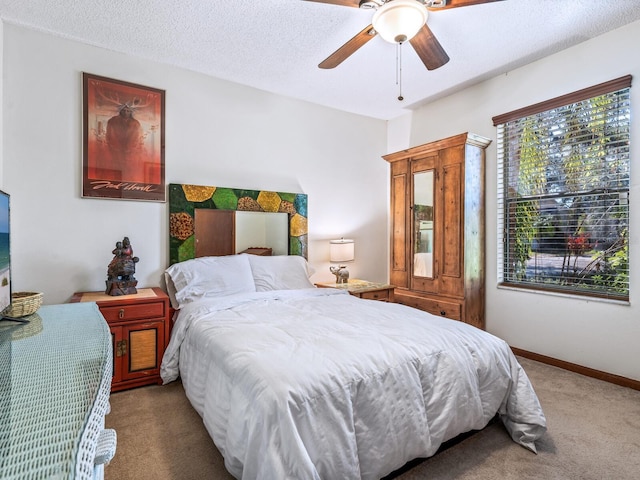 3888 Shady Brook Ln, Sarasota, FL 34243 - carpeted bedroom with a ceiling fan, a textured ceiling, and baseboards