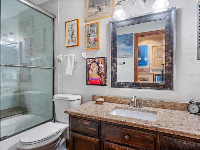 full bathroom with combined bath / shower with glass door, vanity, and toilet